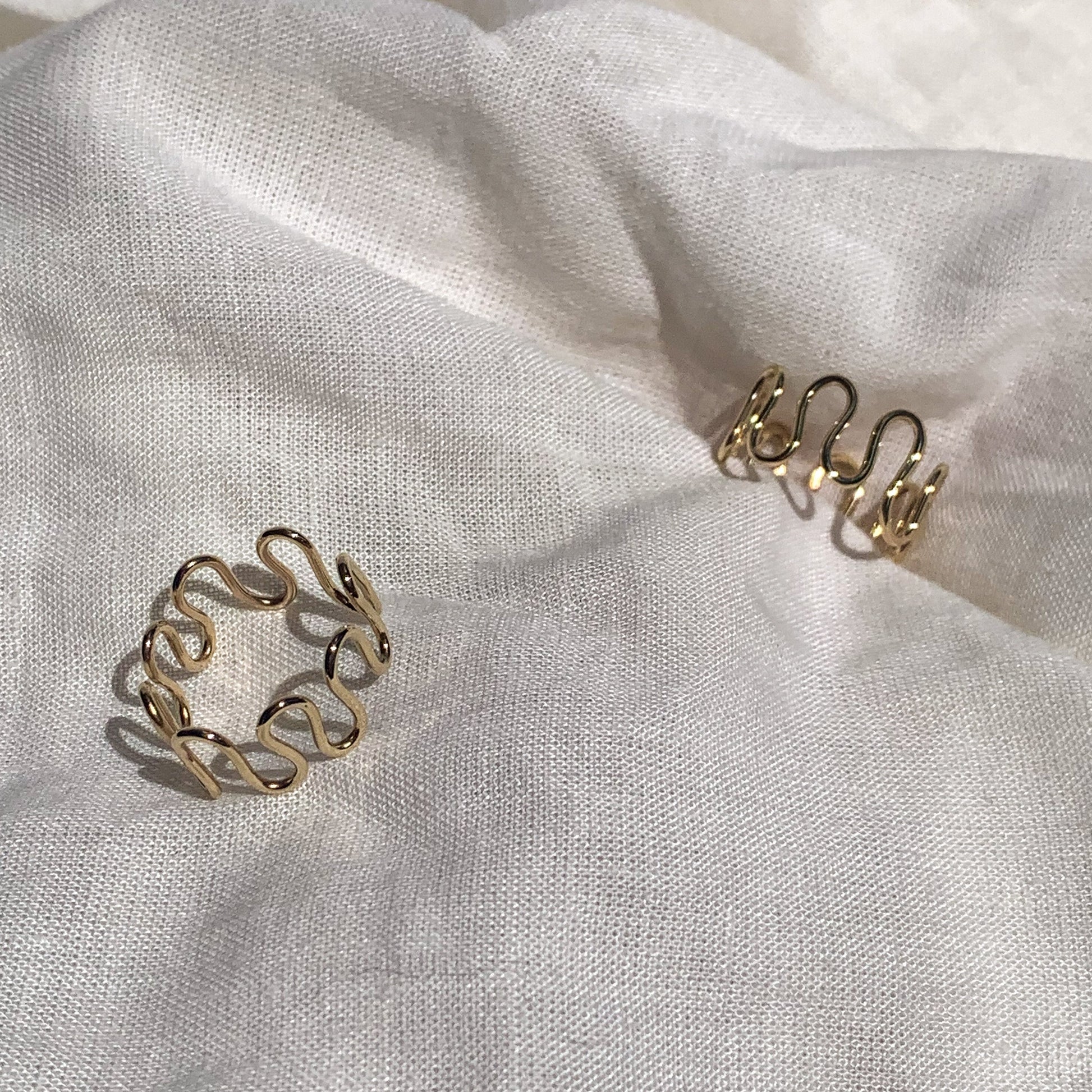 two 9ct yellow gold mr squiggly rings shown in different angles